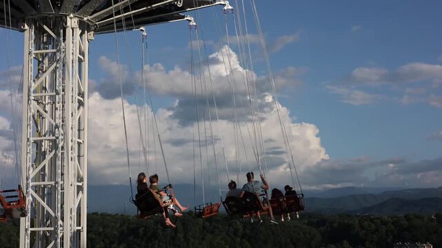 Thrilling rotating swing tower ride in motion, offering stunning panoramic views of the Smoky Mountains in Pigeon Forge, Tennessee