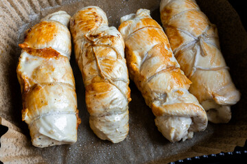 Roasted stuffed chicken breasts on parchment paper