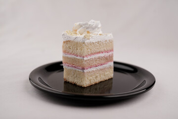 Delicious white forest cake slice on black plate