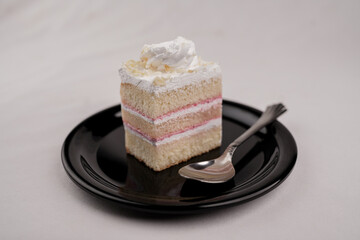 Delicious white forest cake slice on black plate isomatric view