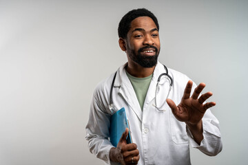 Happy black male doctor explaining therapy results to patient, looking at camera, holding clipboard, professional medical consultation