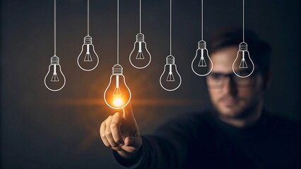 Person touching glowing light bulb hand finger