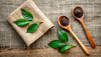 Photo of fresh green tea leaves and dried tea leaves in wooden spoons on a rustic linen cloth