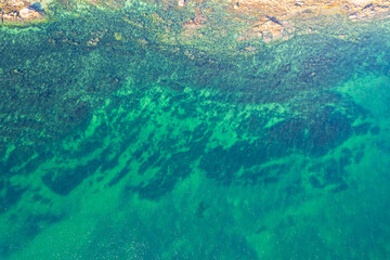 A Top Down Drone Shot of a Rugged Shore and Clear Water. Concept The raw power of the ocean edge.