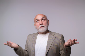 Confused senior man with shocked facial expression. Confused pensioner man. Elderly male showing...