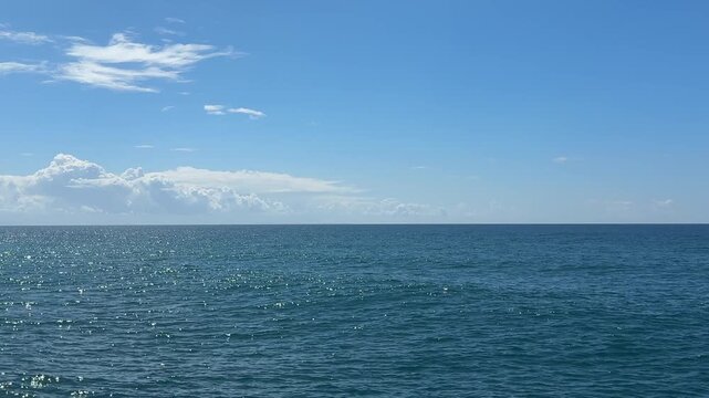 Blue sparkling sea waves and clear sky.