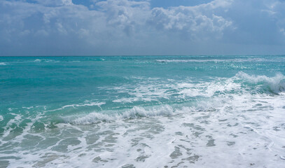 Sea beach shore. Colorful sea beach water. Warm ocean breeze. Summer sea beach. Sea background. Blue ocean. Sandy beach. Ocean waves. Summer seaside. Tropical coastline. Foamy wave splash.