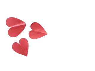 Group of red paper hearts scattered on white background. Heart shaped paper with the concept of feelings and love. Red paper hearts as background or copy space for text and design.