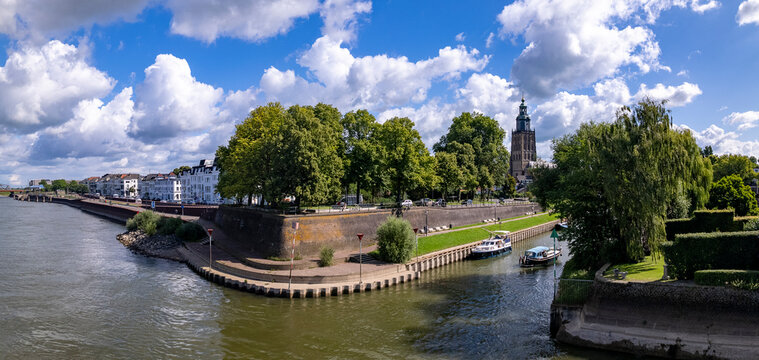 Wide panorama Bult van Ketjen defence city wall part of Zutphen countenance seen from above against vibrant colourful sky with quay visible of river IJssel in low water level reflecting in waterway