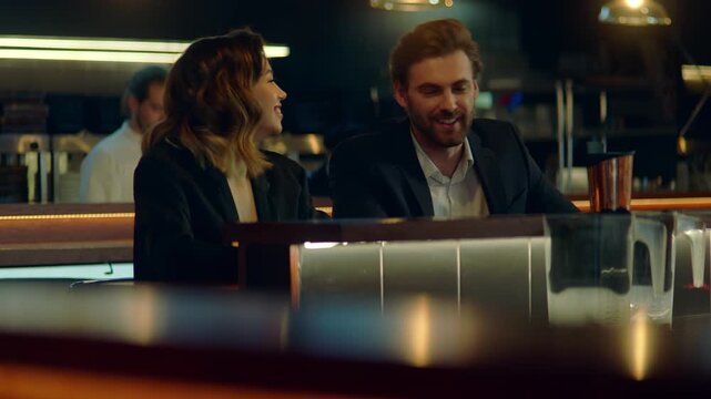 Beautiful Caucasian couple having a date in a stylish restaurant, talking and laughing. Shot with 2x anamorphic lens