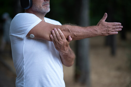 Man Training with Glucose Sensor and Headphones
