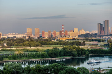 Beautiful cityscape with river, park and residential buildings in Moscow