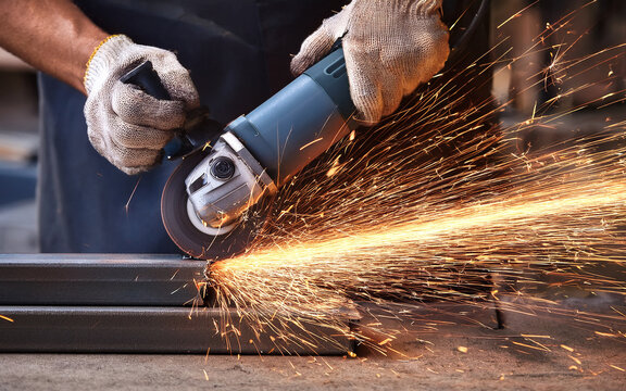 Close-up on hand, worker cutting metal with manual angle grinder sparks - Powered by Adobe