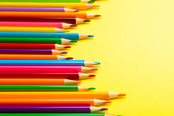 Colored pencils on a bright colored background. Equipment for coloring. Stationery for creativity.Back to school. Flatlay. Children's Creativity and Education. Rainbow.Space for text. Copy space.