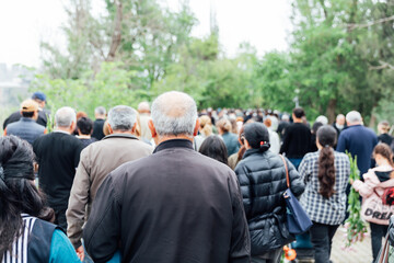 Crowd of people walking along the road