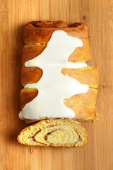 high angle view cinnamon roll loaf cake with icing sugar