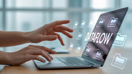 Streamlining Data Management with Dataflow Visualization A Person Typing on a Laptop with Dataflow and Folder Icons Overlayed on the Screen