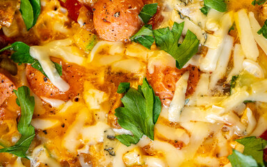 Background with the texture of an omelet with vegetables, sausages, cheese and parsley. Close-up, top view