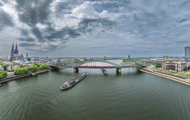 Obraz premium Hohenzollern Bridge, Cathedral in Cologne City, Germany. Drone. Cruise Ship in Background