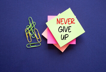 Never give up symbol. Sticky notes with Concept words Never give up. Beautiful deep blue...