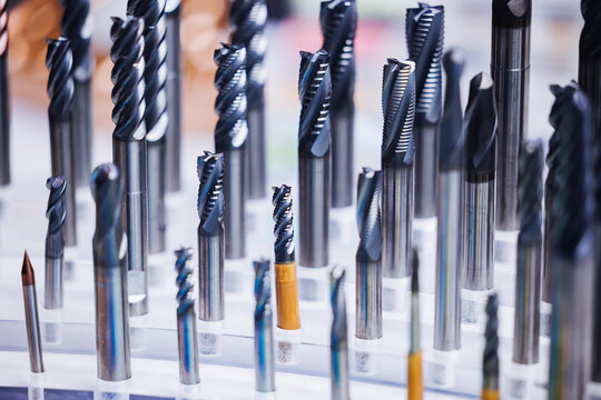 Close-up of various cnc drill bits and milling cutters displayed after machining process