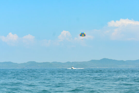 Paragliding above the Andaman sea pulled by a speedboat.