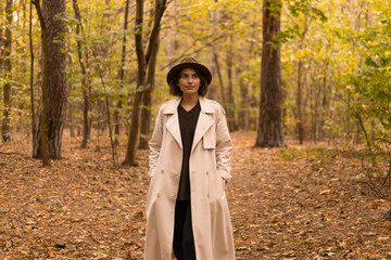 Woman in autumn outfit exploring a colorful forest landscape