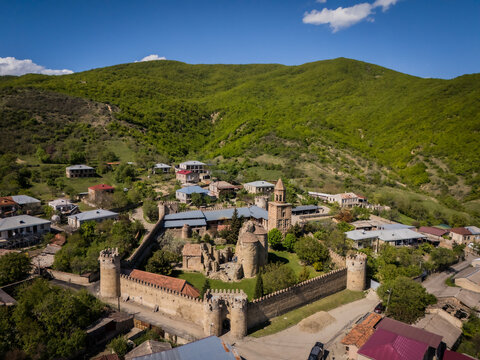 Aerial view of the ancient Ninotsminda cathedral, its weathered stone walls embracing time against the backdrop of lush, verdant hills, Ninotsminda, Kakheti, Georgia.