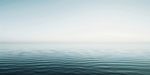 Obraz premium Calm, serene ocean surface with gentle ripples under a soft, hazy sky. Concept of tranquility, peace, minimalist seascape.