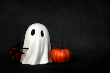 Funny Halloween ghost with Halloween pumpkins and spider with space for text. Halloween concept background