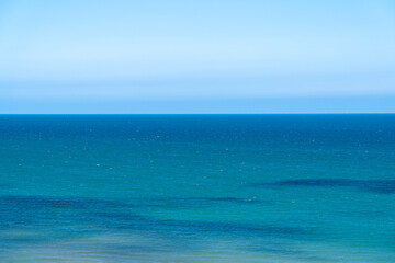A view of the North Sea off the coast of North Norfolk in the UK, Ocean horizon holiday or vacation concept with blue water