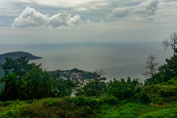 Beautiful coast of Phuket with clouds above and Andaman sea in bird eye view.