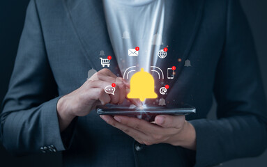 Businessman using smart phone with digital bell icon and floating notification alerts from email, shopping, chat, and phone. Concept of smart technology.