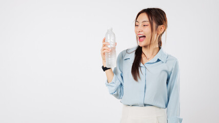 Happy asian woman hold plastic water bottle hydrated after a workout, she enjoys to drink a cool...