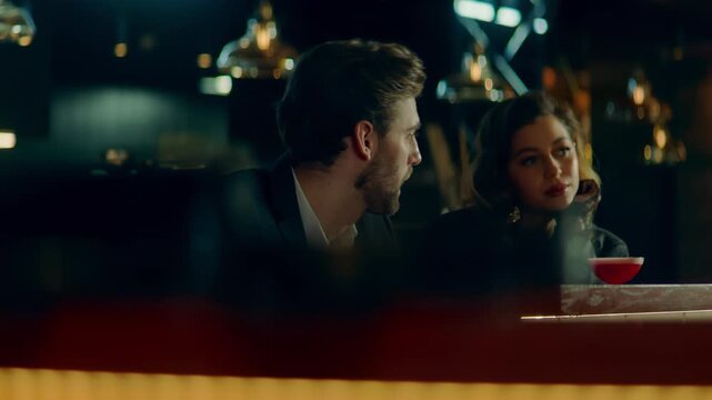 Beautiful Caucasian couple having a date in a stylish restaurant, talking and laughing. Shot with 2x anamorphic lens