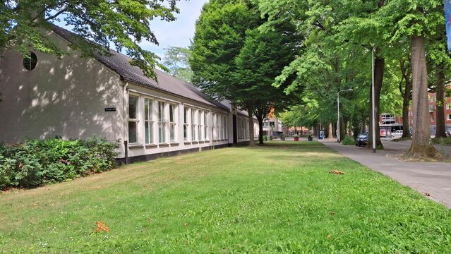 Dutch Residential Architecture - Renovated White Brick Building with Large Windows and Green Lawn in Tilburg