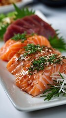 A white plate topped with three pieces of salmon on top of a table