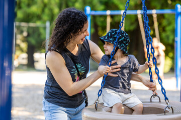 Mother and Young Boy Enjoying Playground Time on a Swing in Burnaby
