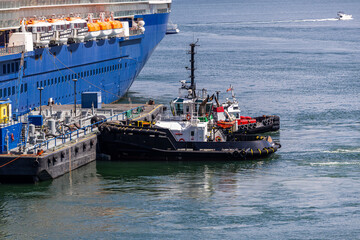 Dockside Tugboats Assisting Docking of Large Passenger Cruise Ship in Vancouver, Canada