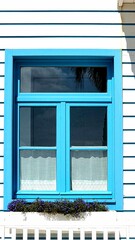 detail of vibrantly colored window in summer house
