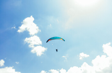 Paragliding against the backdrop of a clear blue sky and mountains.Papraplans in Chegem, Kabardino-Balkaria