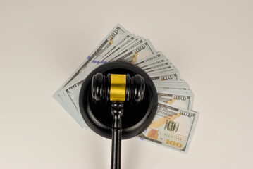The weighty gavel, positioned amidst a stack of money