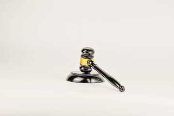 The gavel's dark silhouette against the light background.