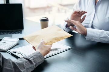 Man employee offering bribe money in envelope to business woman to signing on the contract to joint engage