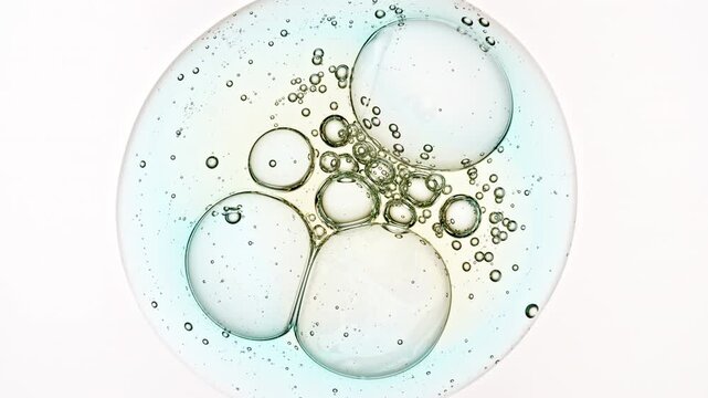 Bubble Cluster, Cells Under a Microscope From a Glass Pipette. Essential Oil, Cosmetic Serum Fluid Gel With Molecule Bubbles. Dermatology science laboratory. Macro Shot of Organic Products. 4k