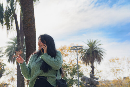 young woman gossiping on the phone with her friends