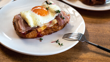 Scrambled eggs on bread, toasted toast. A nice beautiful breakfast of scrambled eggs, a beacon and toasted white bread on a white plate. High quality photo