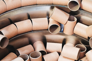 Stack of cardboard tubes for protective packaging and shipping, some of which are cut in half, are...