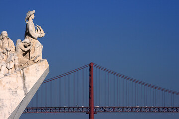 Portugal, Lisbon, Belem District. Monument to the Portuguese voyages of Discovery - 'Padrao dos Descobrimentos' overlooking the River Tagus River. 25th of April Bridge suspension bridge in background.