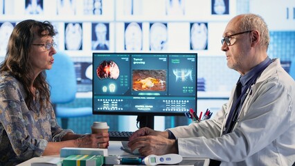 Healthcare expert examines cancer screening scan discussing preventative measures for long term...
